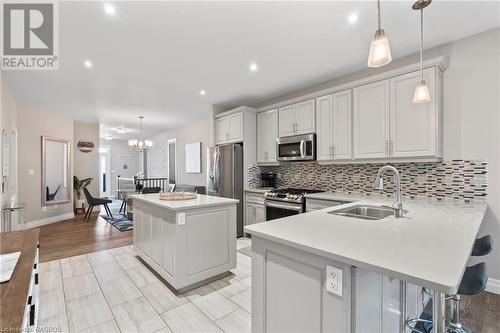 Kitchen featuring stainless steel appliances, hanging light fixtures, sink, and a kitchen island - 466 Normanton Street, Port Elgin, ON - Indoor Photo Showing Kitchen With Double Sink With Upgraded Kitchen