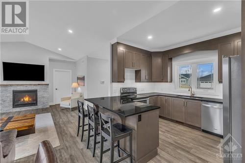 1077 Shearer Drive, Brockville, ON - Indoor Photo Showing Kitchen With Fireplace With Upgraded Kitchen