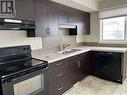 32 4533 Delhaye Way, Regina, SK  - Indoor Photo Showing Kitchen With Double Sink 