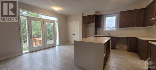 Huge Island, stone countertops, Beautiful sink beside beautiful window - 82 Green Ash Avenue, Ottawa, ON - Indoor Photo Showing Kitchen With Double Sink