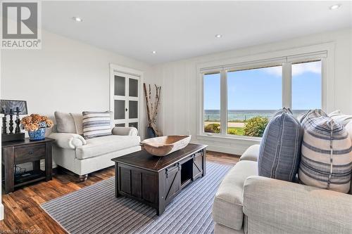 Living room with dark hardwood / wood-style flooring and a water view - 98 North Shore Road, Port Elgin, ON - Indoor Photo Showing Living Room