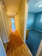 Hall with light hardwood / wood-style flooring - 