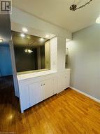 Bathroom with wood-type flooring and a notable chandelier - 