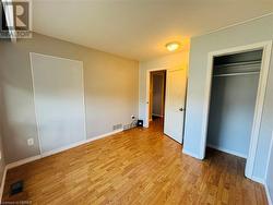 Unfurnished bedroom with light wood-type flooring and a closet - 