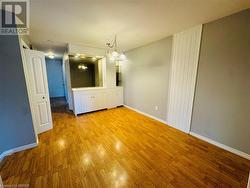 Unfurnished dining area with light wood-type flooring and an inviting chandelier - 