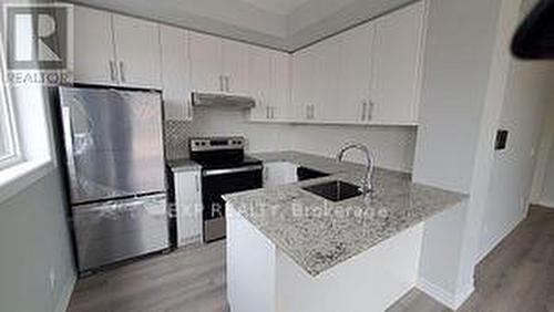 302 - 349 Wheat Boom Drive, Oakville, ON - Indoor Photo Showing Kitchen With Upgraded Kitchen