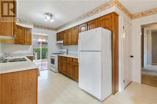 Kitchen with door to right of fridge that leads downstairs - 118 Beley Street, Brockville, ON - Indoor Photo Showing Kitchen With Double Sink