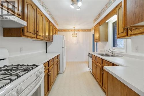 Bright Galley Kitchen with oak cabinetry - 118 Beley Street, Brockville, ON - Indoor Photo Showing Kitchen With Double Sink