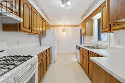 Bright Galley Kitchen with oak cabinetry - 