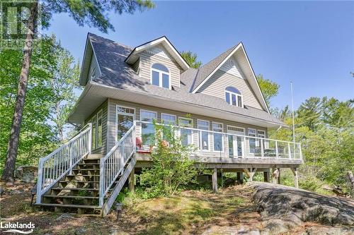 View of front of house with a wooden deck - 1320 360 Island, Port Severn, ON - Outdoor With Deck Patio Veranda