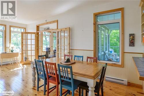 Dining area featuring light wood-type flooring, french doors, and a baseboard radiator - 1320 360 Island, Port Severn, ON - Indoor Photo Showing Dining Room