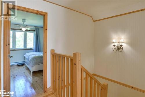 Hall featuring hardwood / wood-style flooring, a baseboard heating unit, and ornamental molding - 1320 360 Island, Port Severn, ON - Indoor Photo Showing Other Room