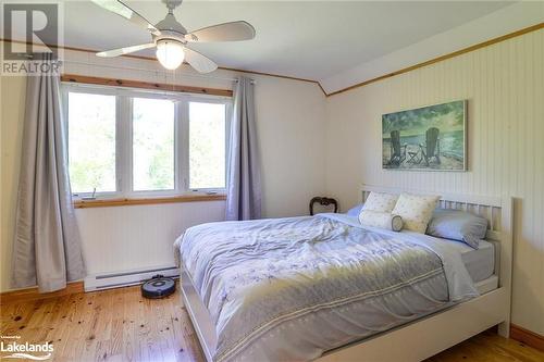 Bedroom featuring light hardwood / wood-style flooring, ceiling fan, and a baseboard radiator - 1320 360 Island, Port Severn, ON - Indoor Photo Showing Bedroom