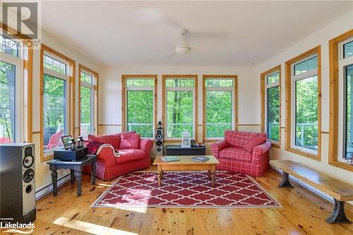 Sunroom featuring a baseboard heating unit, plenty of natural light, and ceiling fan - 1320 360 Island, Port Severn, ON - Indoor Photo Showing Living Room