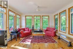 Sunroom featuring a baseboard heating unit, plenty of natural light, and ceiling fan - 