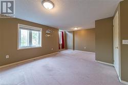 Empty room with a textured ceiling and light carpet - 