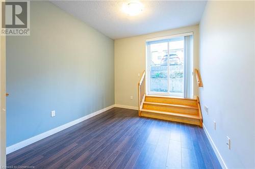 Unfurnished room with dark wood-type flooring and a textured ceiling - 62 Balsam Street Unit# T113, Waterloo, ON - Indoor Photo Showing Other Room