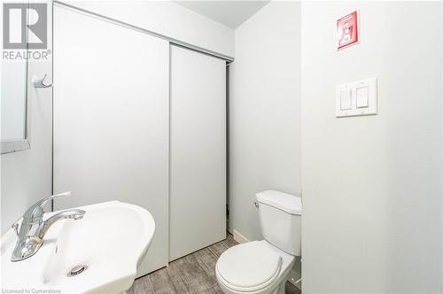 Bathroom with toilet, sink, and hardwood / wood-style flooring - 62 Balsam Street Unit# T113, Waterloo, ON - Indoor Photo Showing Bathroom