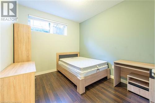 Bedroom with dark wood-type flooring and a textured ceiling - 62 Balsam Street Unit# T113, Waterloo, ON - Indoor Photo Showing Bedroom