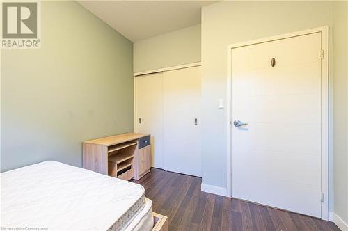 Bedroom with dark hardwood / wood-style flooring, a closet, and a textured ceiling - 62 Balsam Street Unit# T113, Waterloo, ON - Indoor Photo Showing Other Room