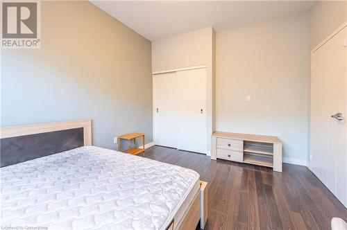 Bedroom with dark hardwood / wood-style flooring and a closet - 62 Balsam Street Unit# T113, Waterloo, ON - Indoor Photo Showing Bedroom