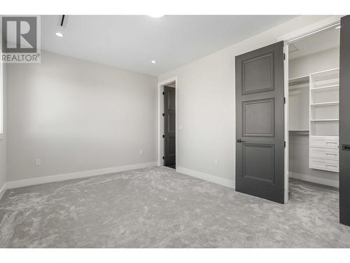 Master Bedroom #3, Walk In Closet & Ensuite - 647 Carnoustie Drive, Kelowna, BC - Indoor Photo Showing Other Room