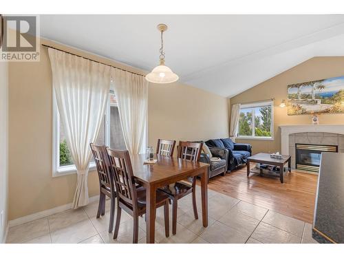 822 Raymer Road, Kelowna, BC - Indoor Photo Showing Dining Room With Fireplace