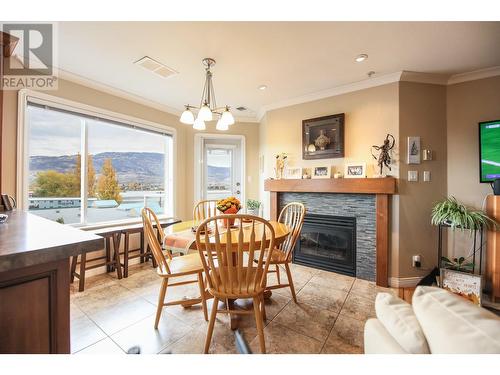 6805 Cottonwood Drive Unit# 400, Osoyoos, BC - Indoor Photo Showing Dining Room With Fireplace