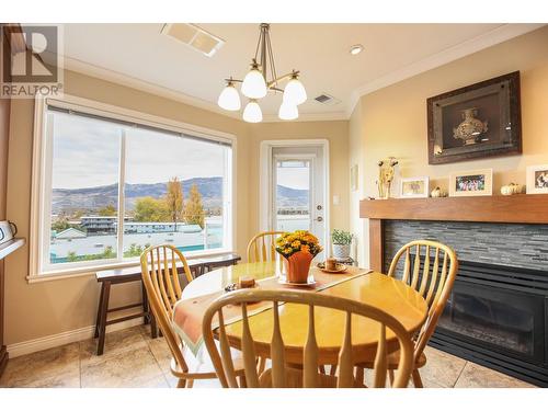 6805 Cottonwood Drive Unit# 400, Osoyoos, BC - Indoor Photo Showing Dining Room With Fireplace