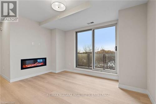 605 - 118 West Street, Port Colborne (878 - Sugarloaf), ON - Indoor Photo Showing Living Room With Fireplace