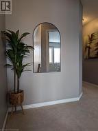 Hallway featuring a textured ceiling and carpet flooring - 