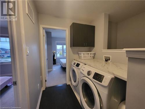 Washroom featuring separate washer and dryer and cabinets - 39 Appleby Street, Kitchener, ON - Indoor Photo Showing Laundry Room