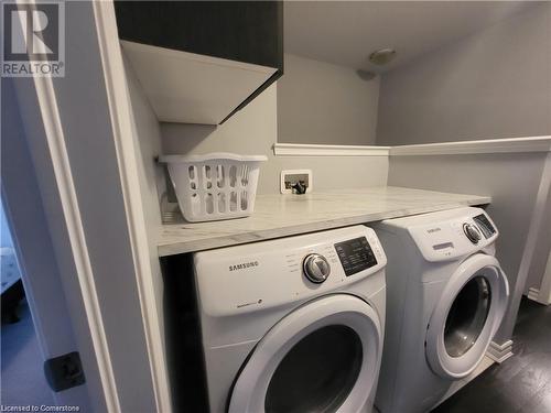 Laundry area featuring dark hardwood / wood-style floors and independent washer and dryer - 39 Appleby Street, Kitchener, ON - Indoor Photo Showing Laundry Room