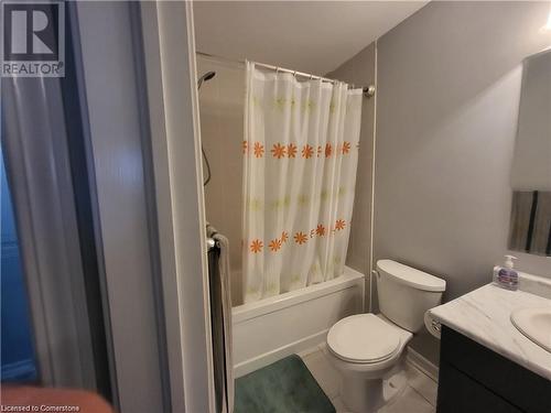 Full bathroom featuring tile patterned flooring, vanity, shower / bath combo with shower curtain, and toilet - 39 Appleby Street, Kitchener, ON - Indoor Photo Showing Bathroom