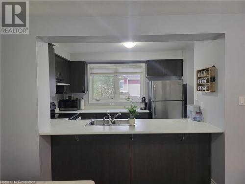 Kitchen with stainless steel appliances, a kitchen bar, sink, and kitchen peninsula - 39 Appleby Street, Kitchener, ON - Indoor Photo Showing Kitchen With Double Sink