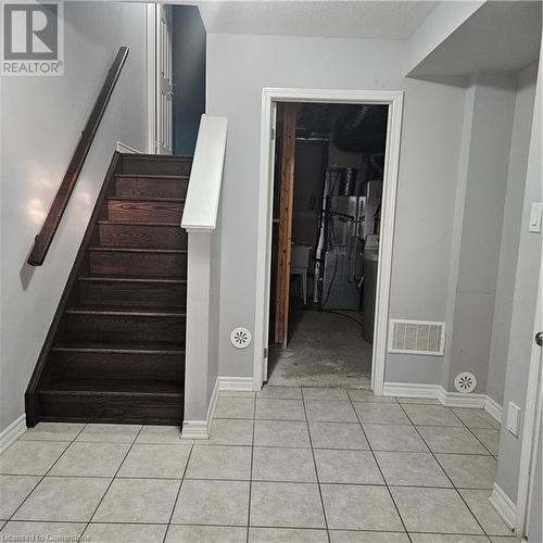 Staircase featuring tile patterned flooring - 39 Appleby Street, Kitchener, ON - Indoor Photo Showing Other Room