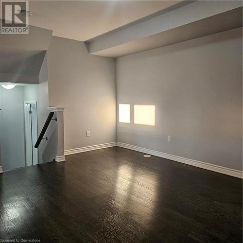 Unfurnished living room featuring dark wood-type flooring and lofted ceiling - 39 Appleby Street, Kitchener, ON - Indoor Photo Showing Other Room