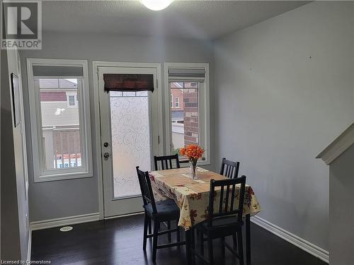 Dining space with a wealth of natural light, a textured ceiling, and dark hardwood / wood-style flooring - 39 Appleby Street, Kitchener, ON - Indoor Photo Showing Dining Room