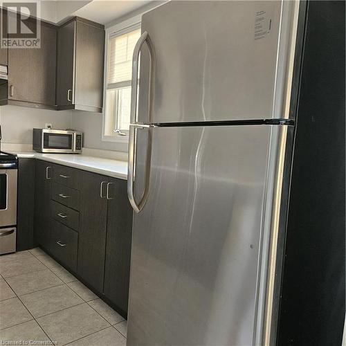 Kitchen with stainless steel fridge, stove, and light tile patterned flooring - 39 Appleby Street, Kitchener, ON - Indoor Photo Showing Kitchen With Stainless Steel Kitchen