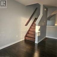 Staircase featuring hardwood / wood-style floors - 