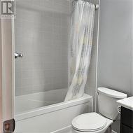 Full bathroom with vanity, toilet, and shower / tub combo - 