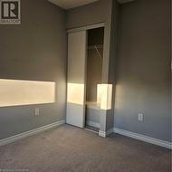 Unfurnished bedroom with carpet floors and a closet - 