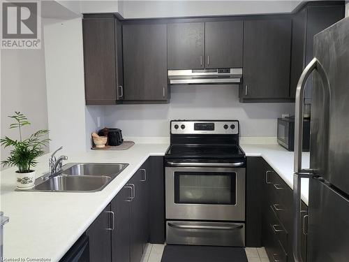 Kitchen featuring stainless steel appliances, sink, and light tile patterned floors - 39 Appleby Street, Kitchener, ON - Indoor Photo Showing Kitchen With Stainless Steel Kitchen With Double Sink