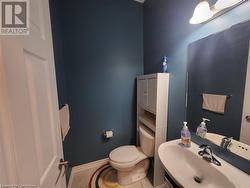 Bathroom featuring tile patterned flooring, sink, and toilet - 