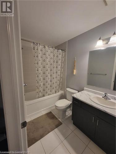 Full bathroom with shower / bath combo, toilet, vanity, and tile patterned floors - 39 Appleby Street, Kitchener, ON - Indoor Photo Showing Bathroom