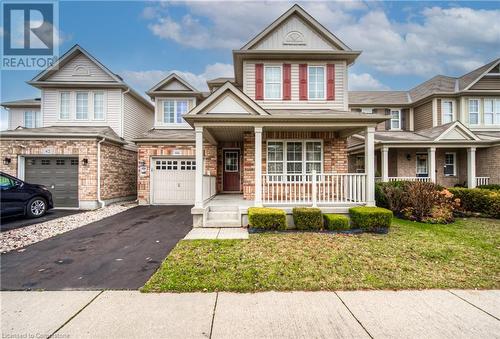 View of front of home featuring a garage, a porch, and a front yard - 66 Abbott Crescent, Cambridge, ON - Outdoor With Deck Patio Veranda With Facade