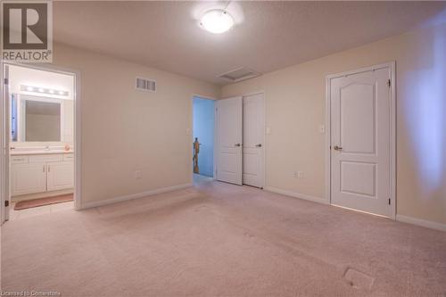 Unfurnished bedroom with ensuite bath, sink, light colored carpet, and a closet - 66 Abbott Crescent, Cambridge, ON - Indoor Photo Showing Other Room