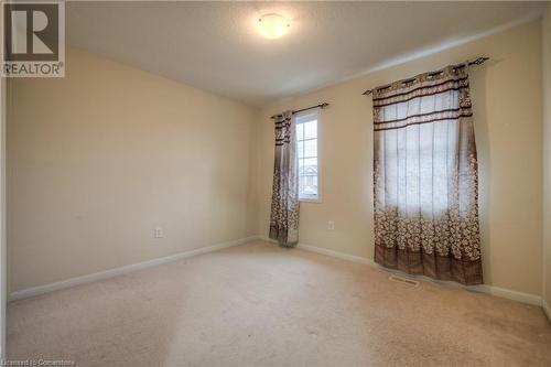 Carpeted spare room featuring a textured ceiling - 66 Abbott Crescent, Cambridge, ON - Indoor Photo Showing Other Room