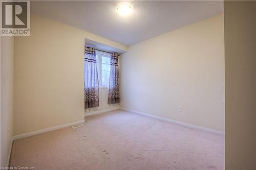 Spare room with a textured ceiling and light colored carpet - 66 Abbott Crescent, Cambridge, ON - Indoor Photo Showing Other Room