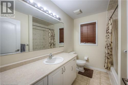 Full bathroom with toilet, vanity, shower / bath combination with curtain, and tile patterned flooring - 66 Abbott Crescent, Cambridge, ON - Indoor Photo Showing Bathroom